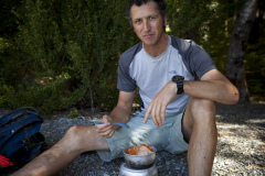 Dallas Hewett preparing a meal at Mavora Lakes, Southland, New Zealand.