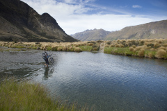Dallas Hewett crossing the Mararoa River, Southland, New Zealand.