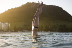 Kristin Crook soaks in the early summer sunshine during a swim at Main Beach, Mount Maunganui, Bay of Plenty, New Zealand.