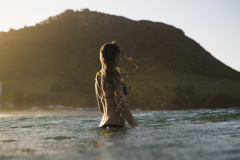 Kristin Crook soaks in the early summer sunshine during a swim at Main Beach, Mount Maunganui, Bay of Plenty, New Zealand.