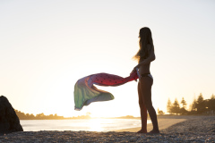 Kristin Crook relaxes in the sunshine at the beach, Mount Maunganui, Bay of Plenty, New Zealand.