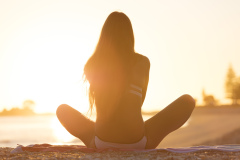 Kristin Crook relaxes in the sunshine at the beach, Mount Maunganui, Bay of Plenty, New Zealand.