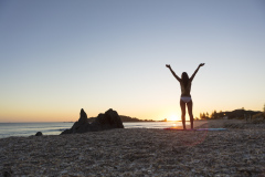 Kristin Crook relaxes in the sunshine at the beach, Mount Maunganui, Bay of Plenty, New Zealand.