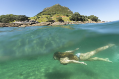 Kristin Crook swims in the sunshine at the beach, Mount Maunganui, Bay of Plenty, New Zealand.