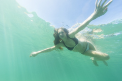 Kristin Crook swims in the sunshine at the beach, Mount Maunganui, Bay of Plenty, New Zealand.
