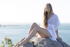 Kristin Crook soaks in the early summer sunshine at Main Beach, Mount Maunganui, Bay of Plenty, New Zealand.