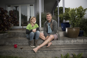 Paul and Shelley Hersey sit on their "worry-free" steps at their home in Warrington, Dunedin, New Zealand.