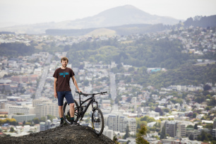 Bike Otago owner and founder of Black Seal Imports Kashi Leuchs in his backyard of Signal Hill above the city of Dunedin, New Zealand.